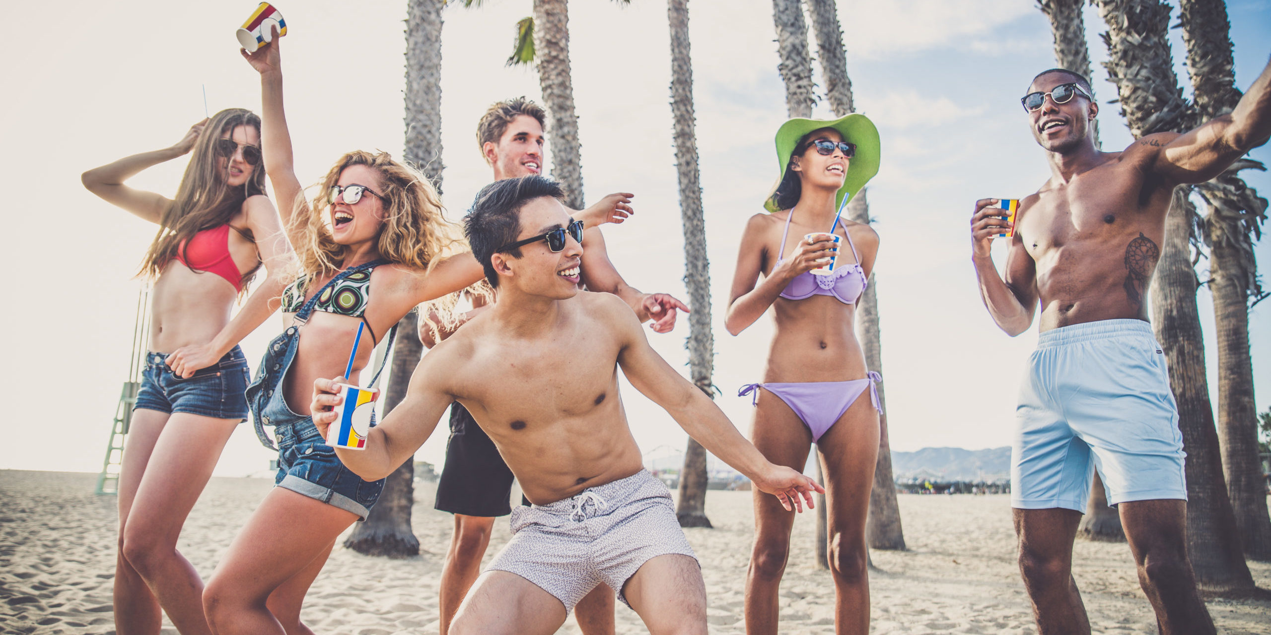 Group,Of,Friends,Having,Party,On,The,Beach,,Dancing,And